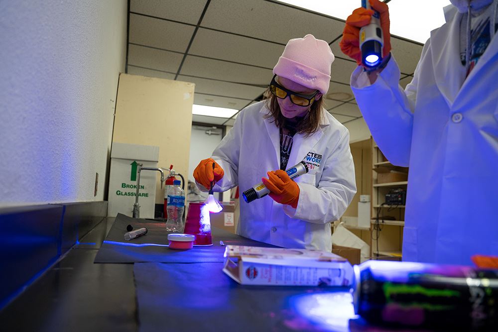 Students using UV flashlight to examine evidence